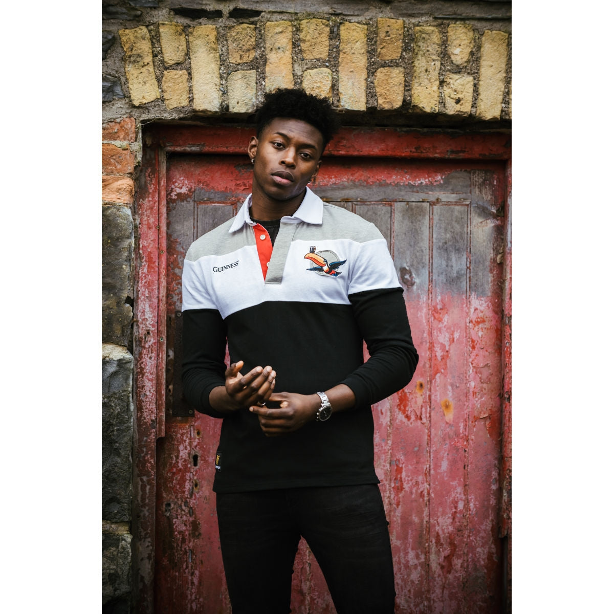 A young man wearing a Guinness Toucan Rugby Jersey.