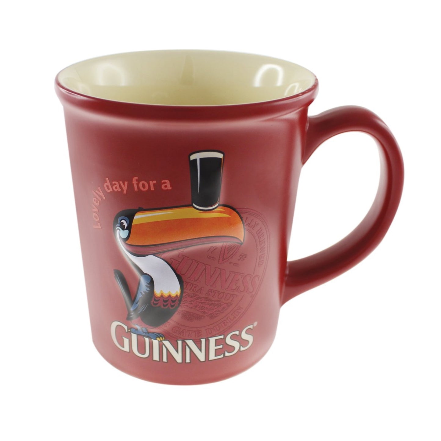 An official merchandise red Guinness® Toucan Mug featuring a toucan holding a pint on its beak, with the text "lovely day for a Guinness.