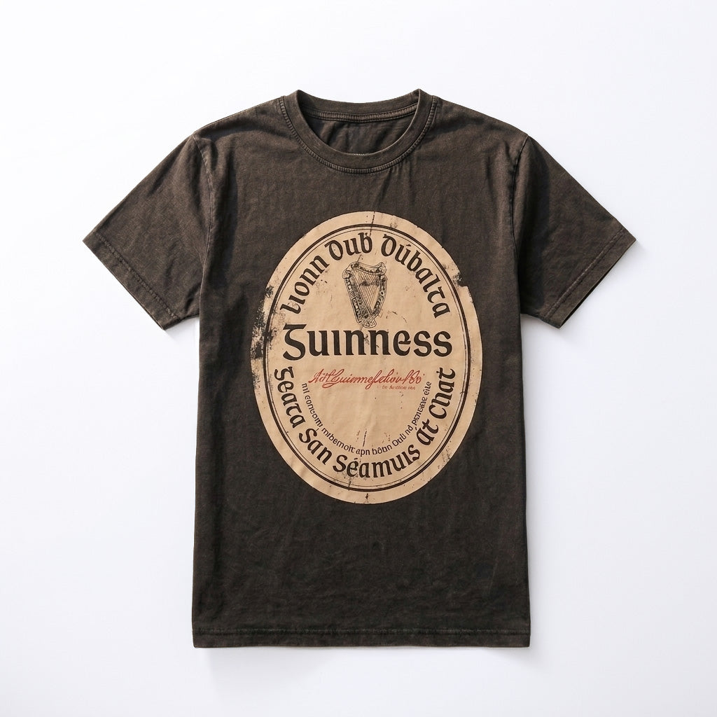 Introducing the Guinness Black Distressed Label Tee, a unisex t-shirt featuring a vintage-style distressed label graphic with the iconic Guinness logo and shield emblem printed in beige and black on the front.