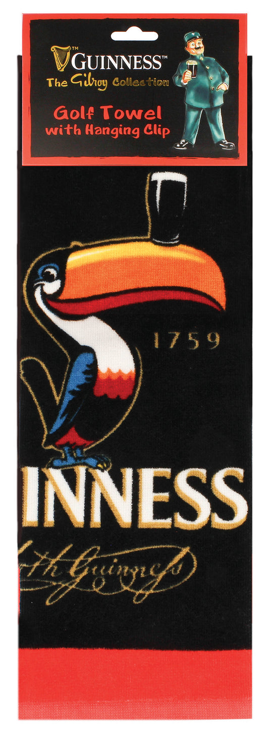 The Guinness Webstore US Guinness Gilroy Golf Towel is a black, absorbent golf accessory featuring a colorful toucan with a beer glass on its beak, the year 1759, and the brand name. The packaging showcases "Guinness The Gilroy Collection" and "Golf Towel with Hanging Clip.