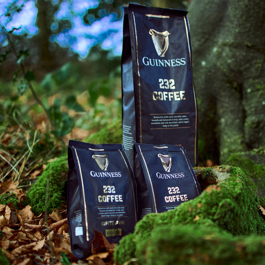 Three limited-edition bags of Guinness Ground Coffee 227g inspired by rugby fans sitting on the ground.