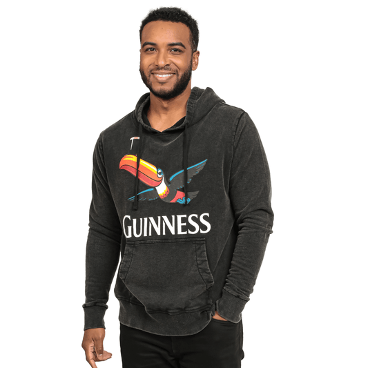 A Guinness enthusiast sporting a Guinness Premium Label Toucan Hoodie.