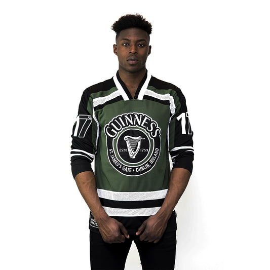 A man wearing a polyester Guinness Green & White hockey jersey.