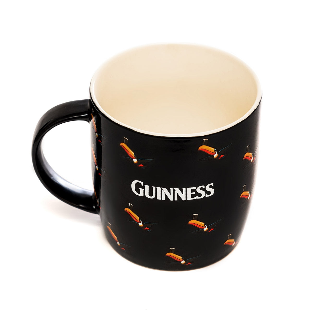 A black Guinness mug with orange fish on it has been replaced with a Guinness Black Mug with Multiple Flying Toucans.