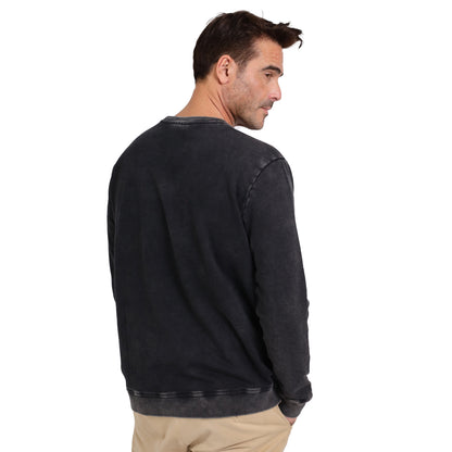 Man wearing a Guinness Embossed Print Trademark Sweater by Guinness Webstore US and beige pants, facing away from the camera and looking over his shoulder against a plain white background.
