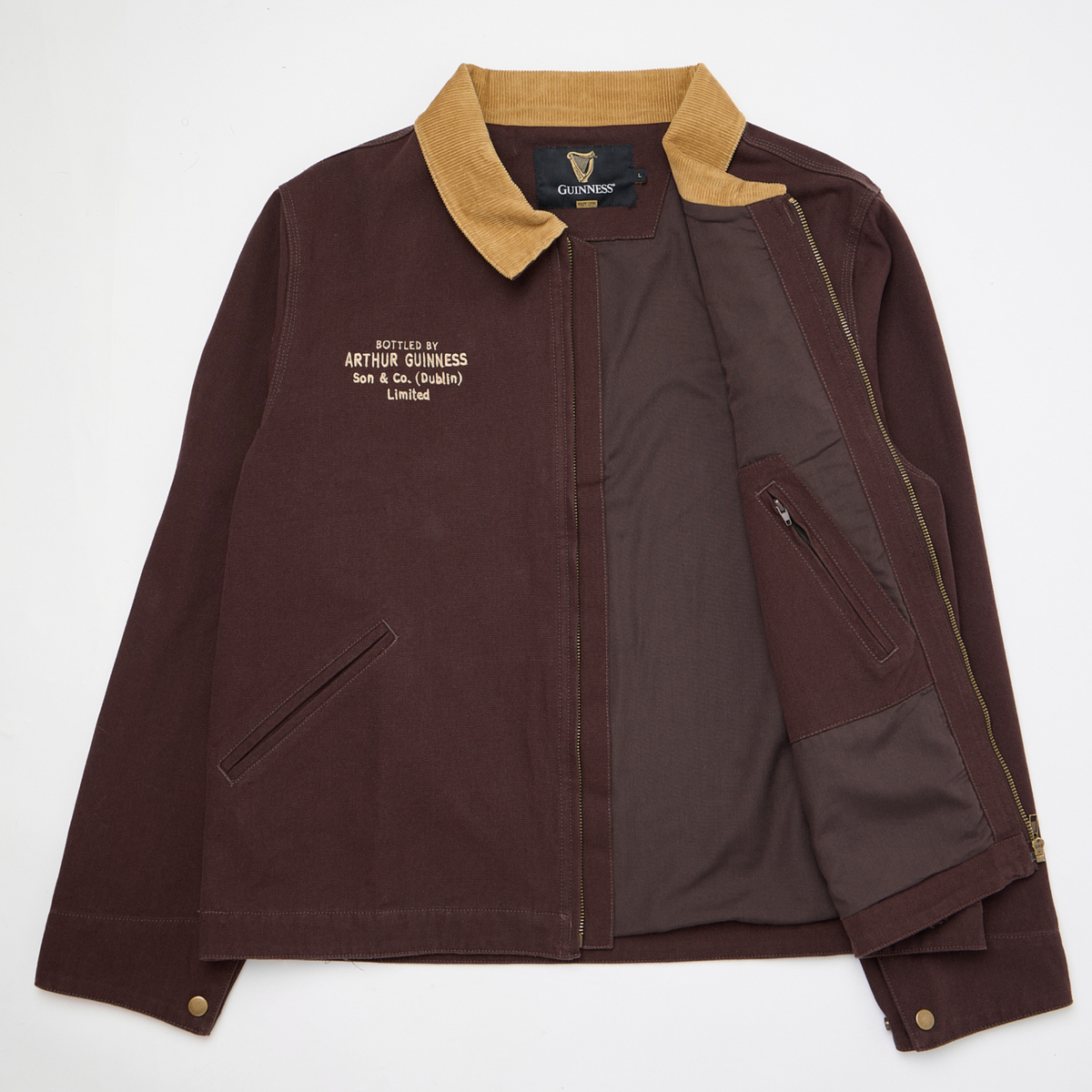 Guinness Cooperage Work Jacket: brown heavyweight cotton canvas with tan corduroy collar, chest Guinness branding, zippered inner pocket—classic style shown flat on white.