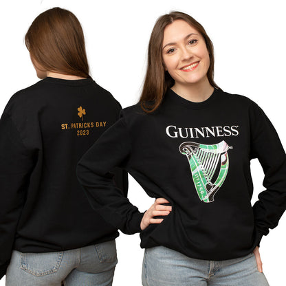 A woman wearing a limited edition black Guinness St. Patrick's Day Limited Edition Sweatshirt with the harp logo, perfect for St. Patrick's Day.