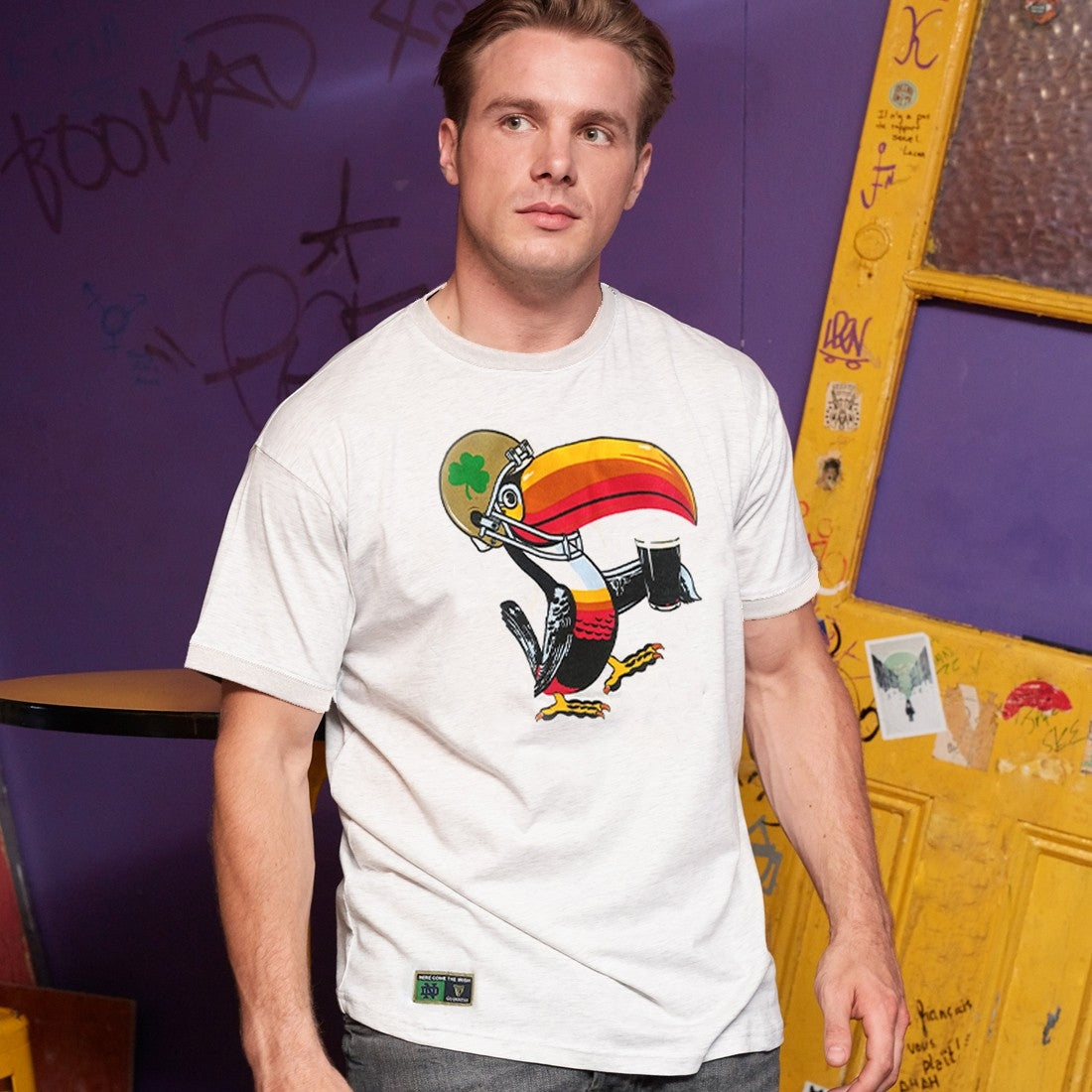 A man wearing a Guinness Notre Dame Toucan T-Shirt White.