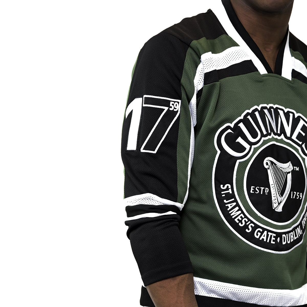 Arthur Guinness wearing a Green & White hockey jersey with the Guinness harp logo.