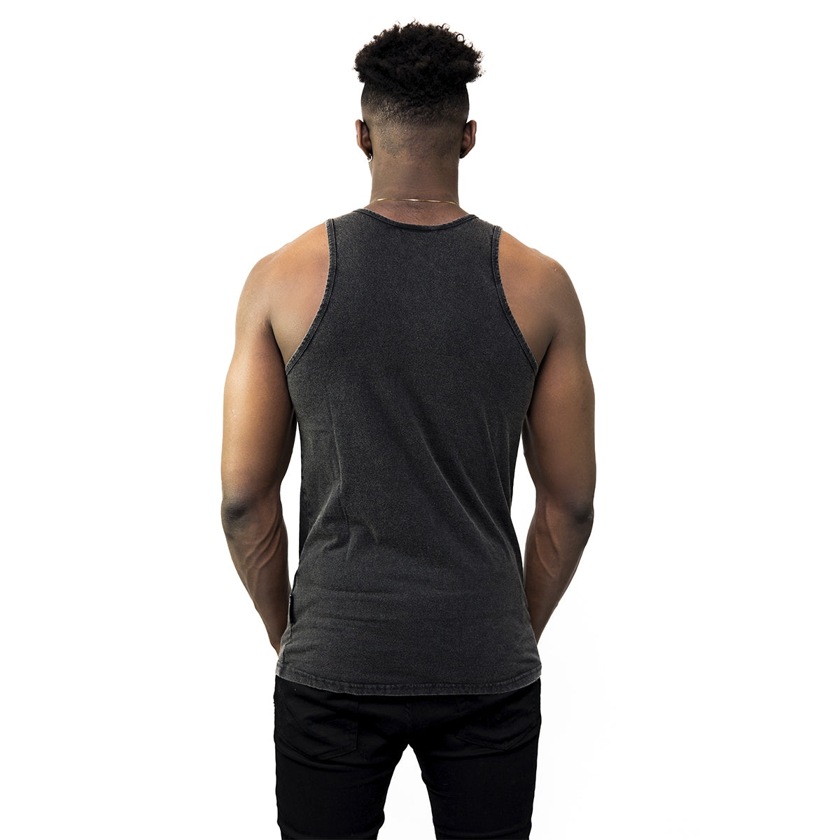 A man wearing a Guinness Washed Extra Stout Tank Top, perfect for the summer months.