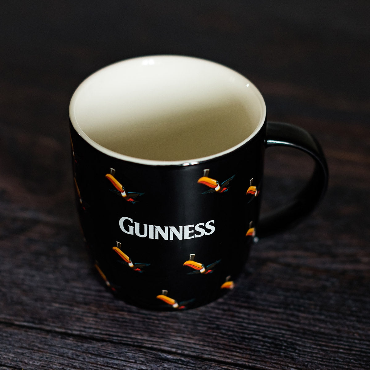 Guinness Black Mug with Multiple Flying Toucans by Guinness.