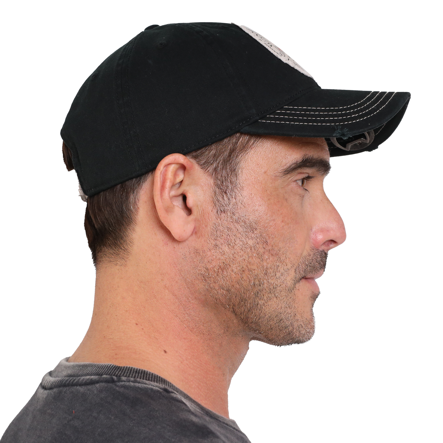 A man wearing a black Guinness Gaelic Bottle Opener Cap is shown in profile against a plain background.