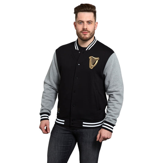 A sporty man donning a Guinness Letterman Jacket.
