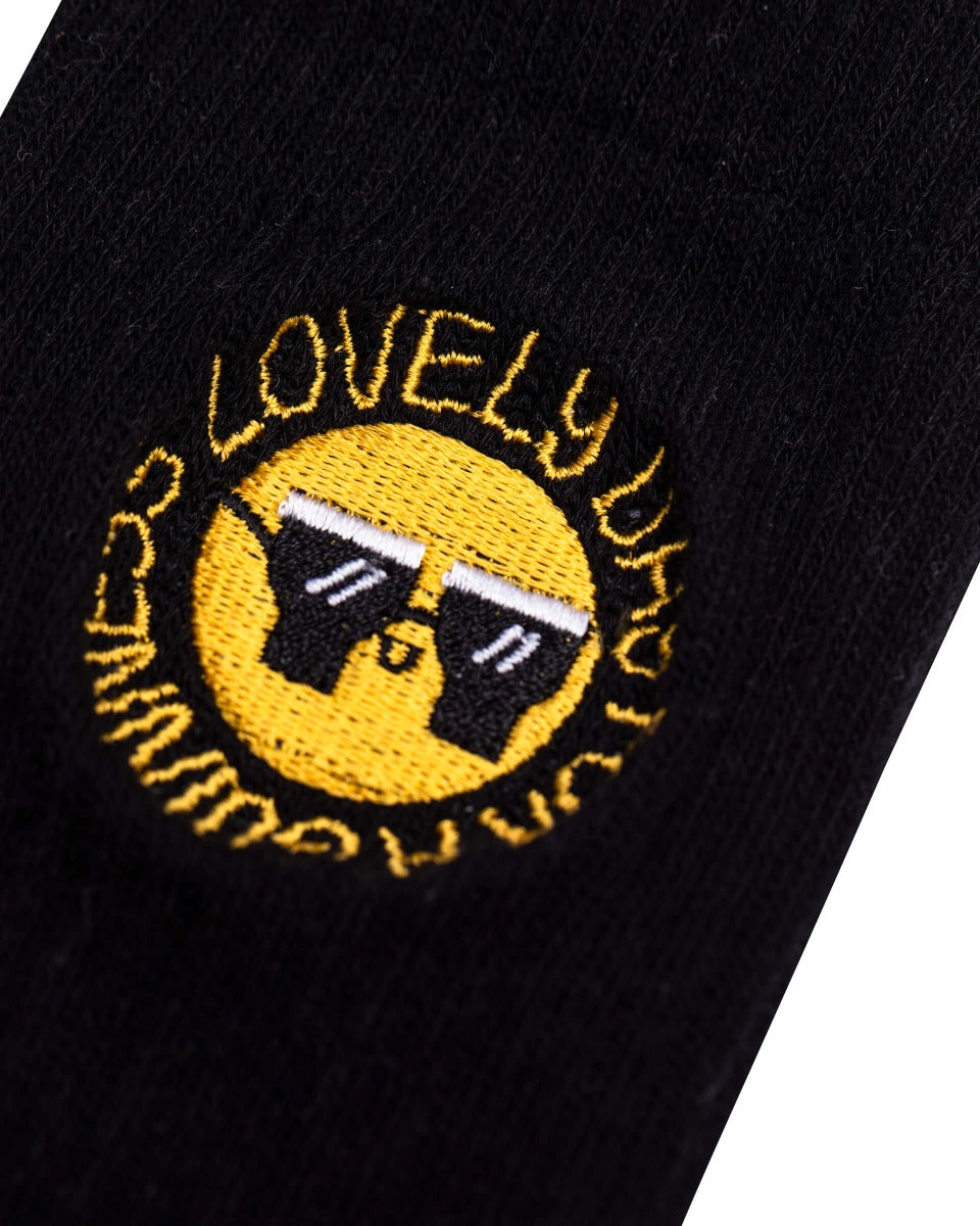 A stylish Guinness black sock with a smiley face on it.