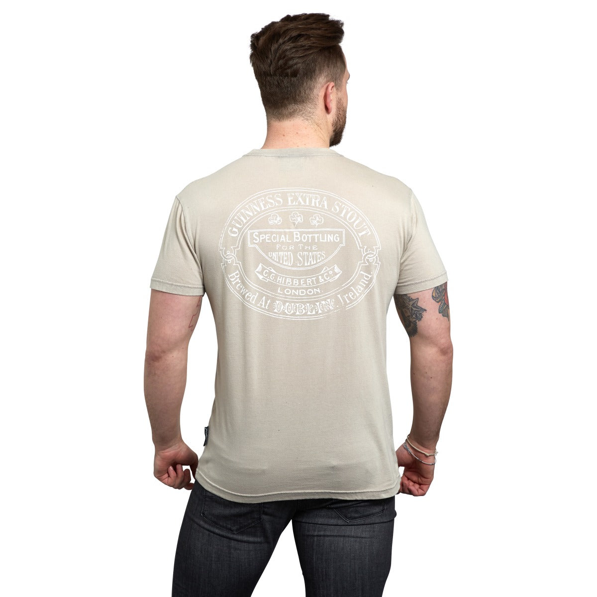 The back view of a man wearing a Guinness Trademark Label T-Shirt Beige.