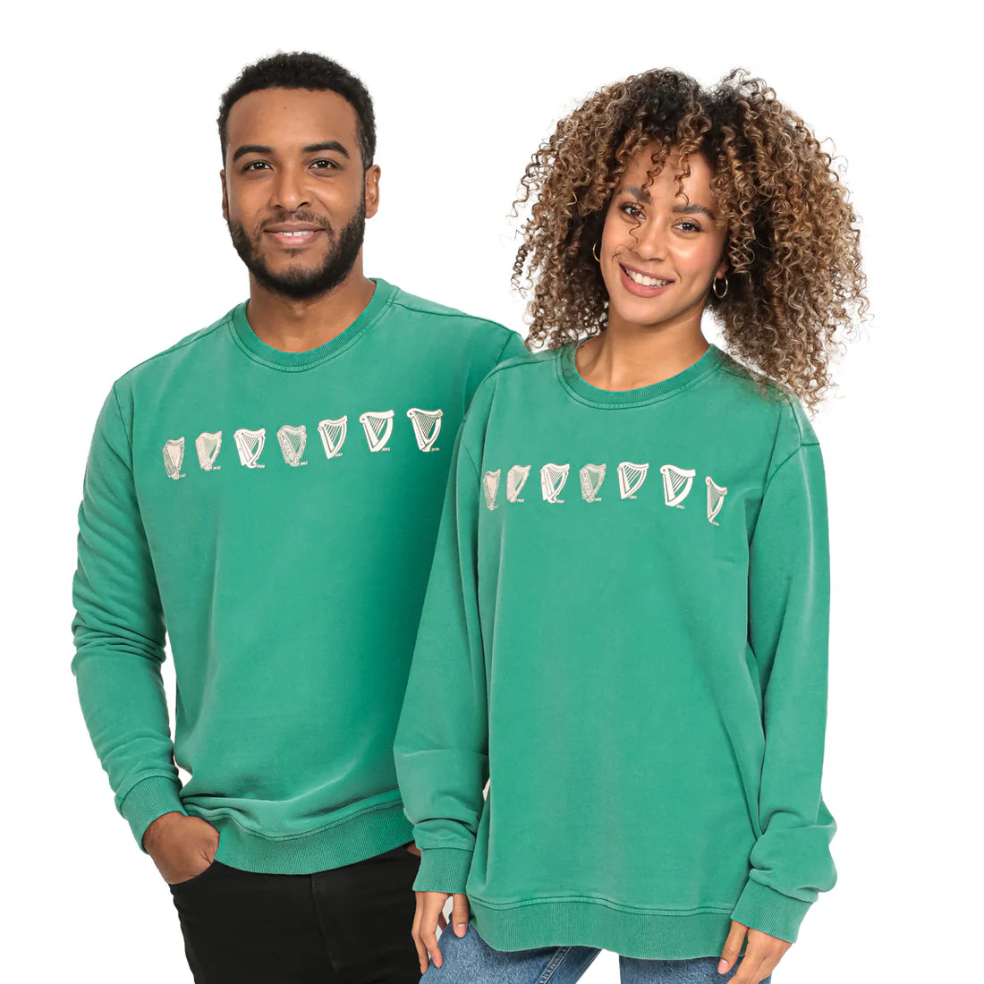 Two people wearing matching Guinness Evolution Harp Green Sweatshirts from the Guinness Webstore US, smiling and standing side by side.