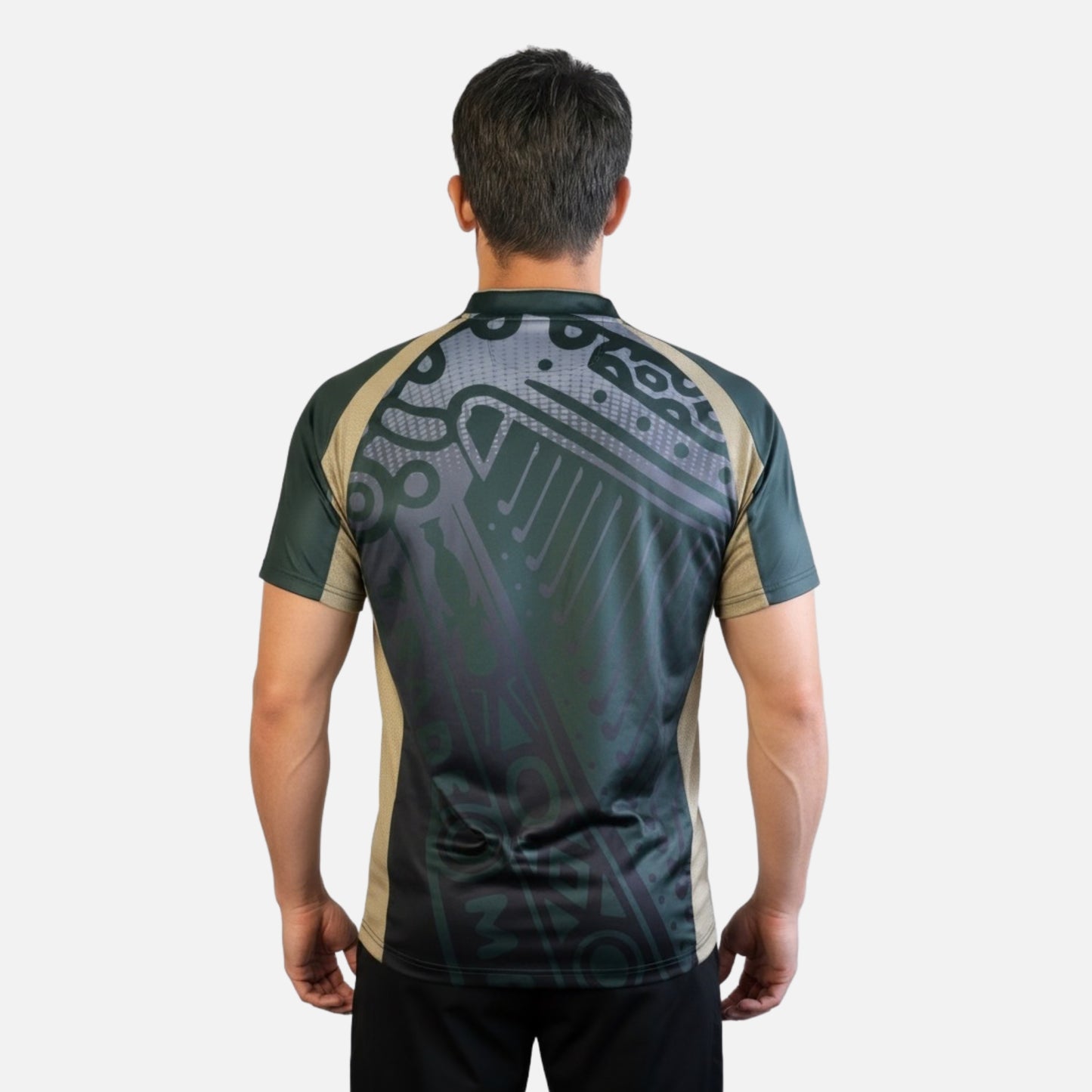 A man faces away, wearing the Guinness Retro Harp Performance Soccer Jersey by Guinness, featuring a short-sleeve design and an abstract dark and beige pattern on the back, set against a plain light background.