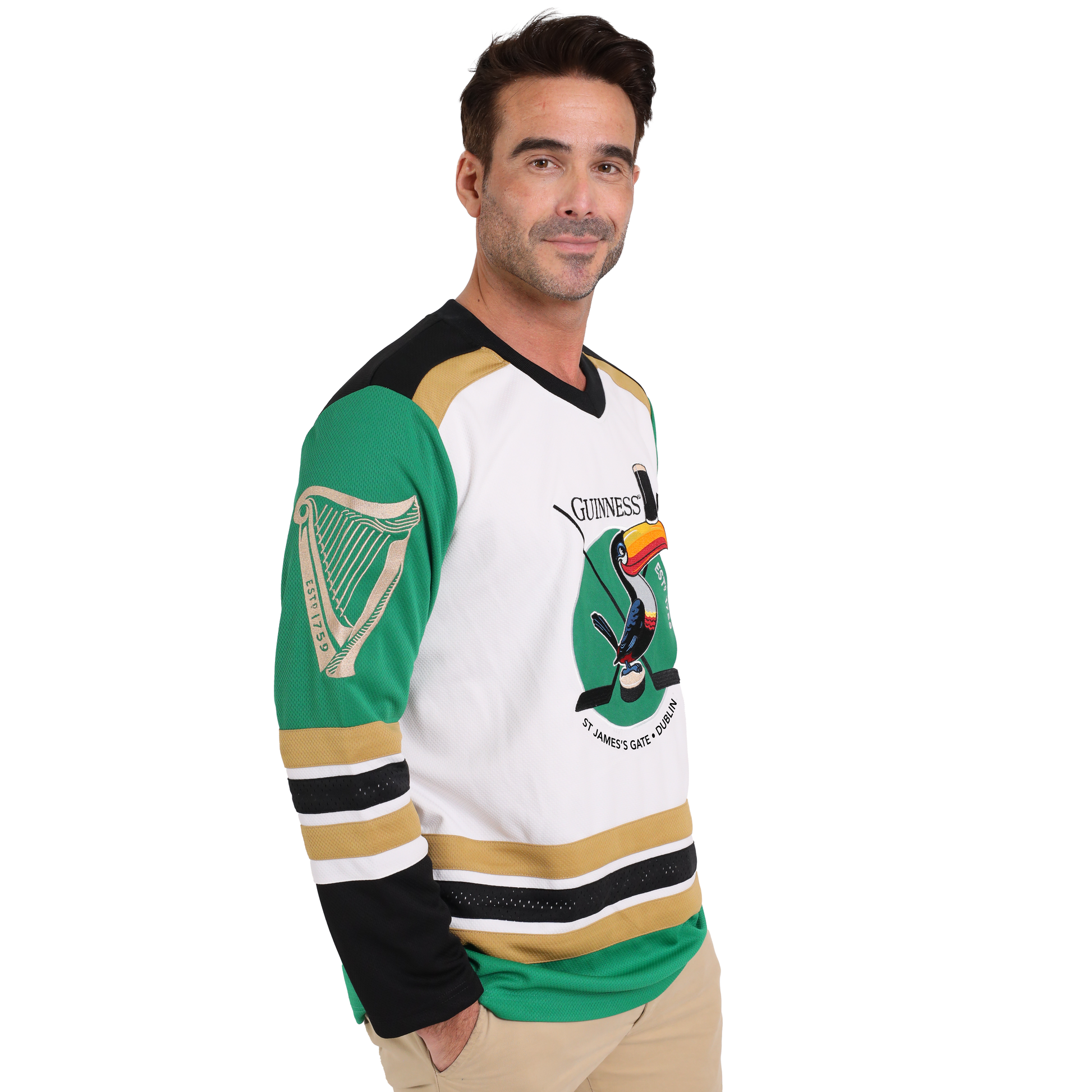 A man wearing a Guinness Toucan Hockey Jersey made of recycled polyester.