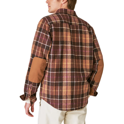 The back view of a man wearing a Guinness Wool Plaid Over Shirt With Elbow Patch - Brown Plaid from the Guinness Webstore US.