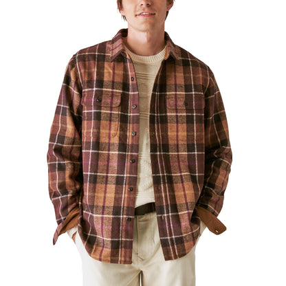 A man wearing a Guinness Wool Plaid Over Shirt With Elbow Patch - Brown Plaid from the Guinness Webstore US.