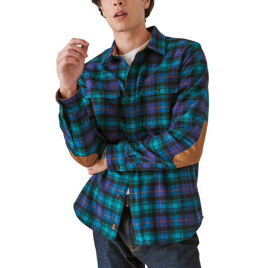 A man wearing a Guinness Webstore US Guinness Wool Plaid Over Shirt With Elbow Patch - Green Plaid, limited edition.