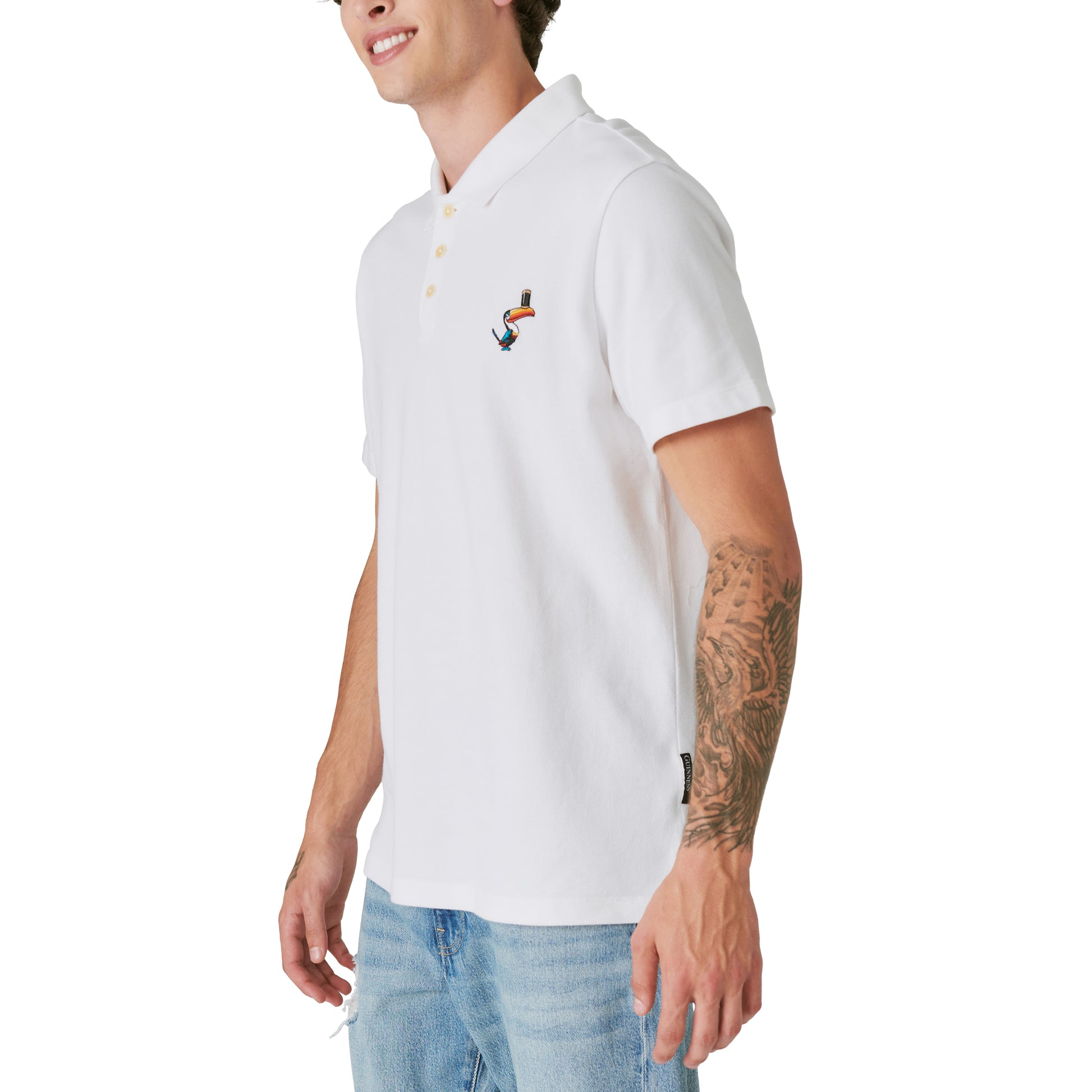 A man wearing a limited edition Guinness Webstore US - Bright White Polo shirt and jeans.