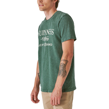 A man wearing a limited edition Lucky Brand Guinness Webstore US Cobrand Tee.