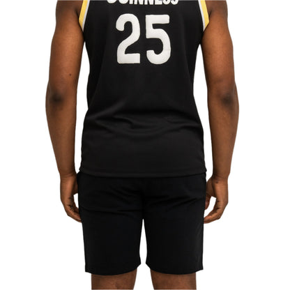 A person facing away from the camera wears a black sleeveless jersey with "GUINNESS" and the number 25 on the back, paired with Guinness Seb Curi Beach Short - Black from Guinness Webstore US.