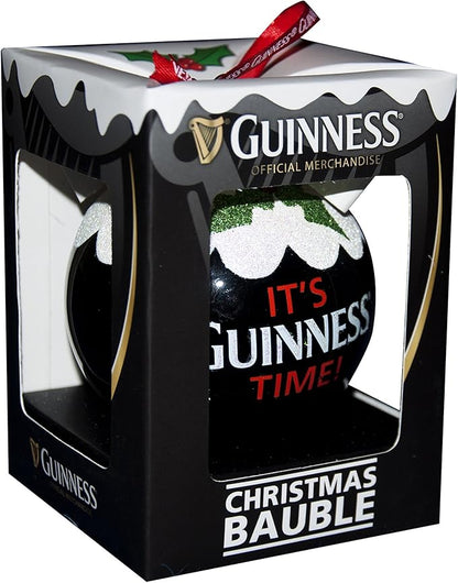 The Christmas Holiday Pudding Bauble by Guinness, with its black packaging featuring the phrase "It's Guinness Time!" and embellished with a decorative holly design, perfectly captures the festive spirit as a charming tree decoration.