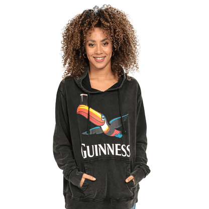 A woman sporting a trendy Guinness Premium Label Toucan Hoodie.