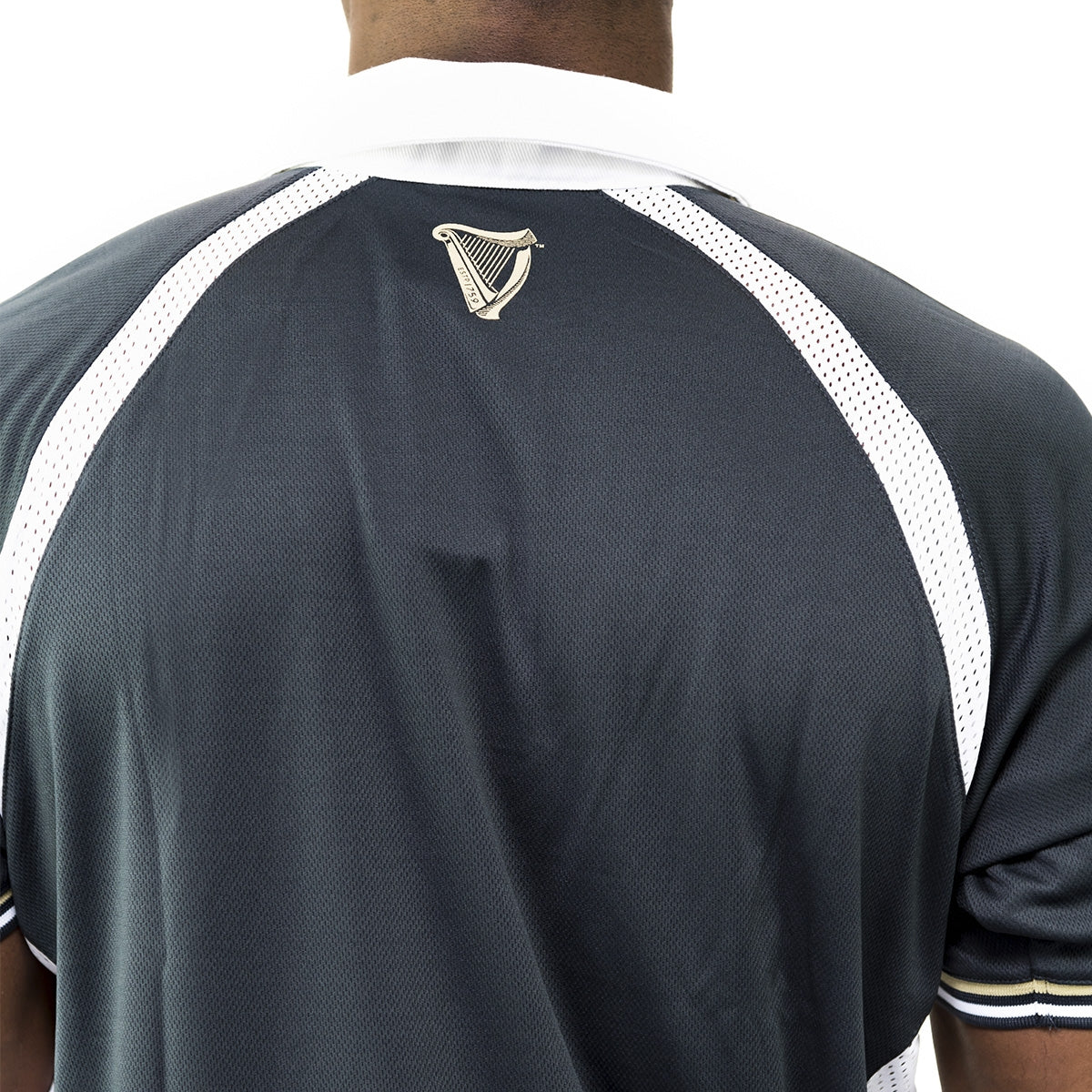 The back view of a man wearing a Guinness Made of More Rugby Jersey with moisture-wicking performance.