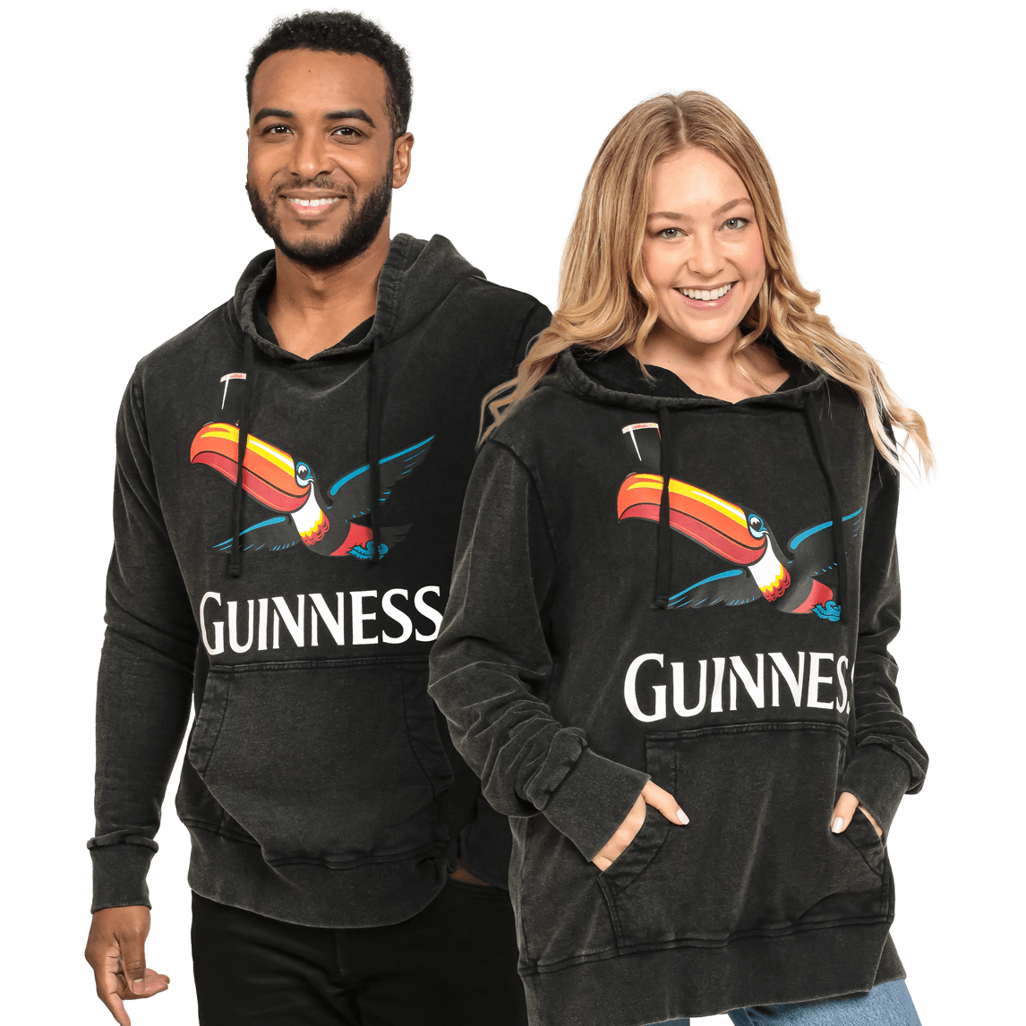 Two people wearing a Guinness Premium Label Toucan Hoodie featuring a Toucan emblem.
