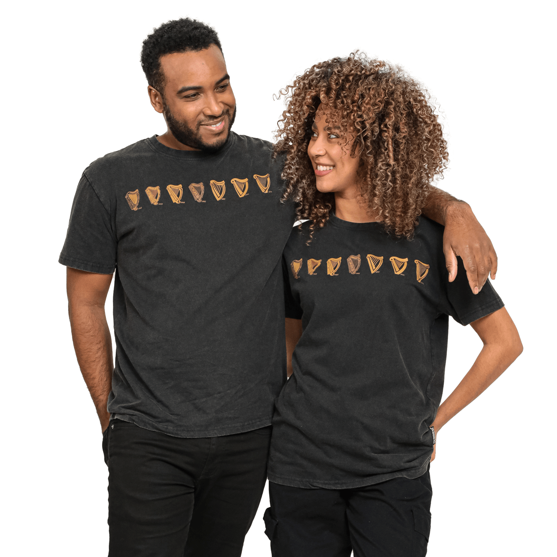 A man and woman standing next to each other wearing a Guinness Evolution Harp Tee.