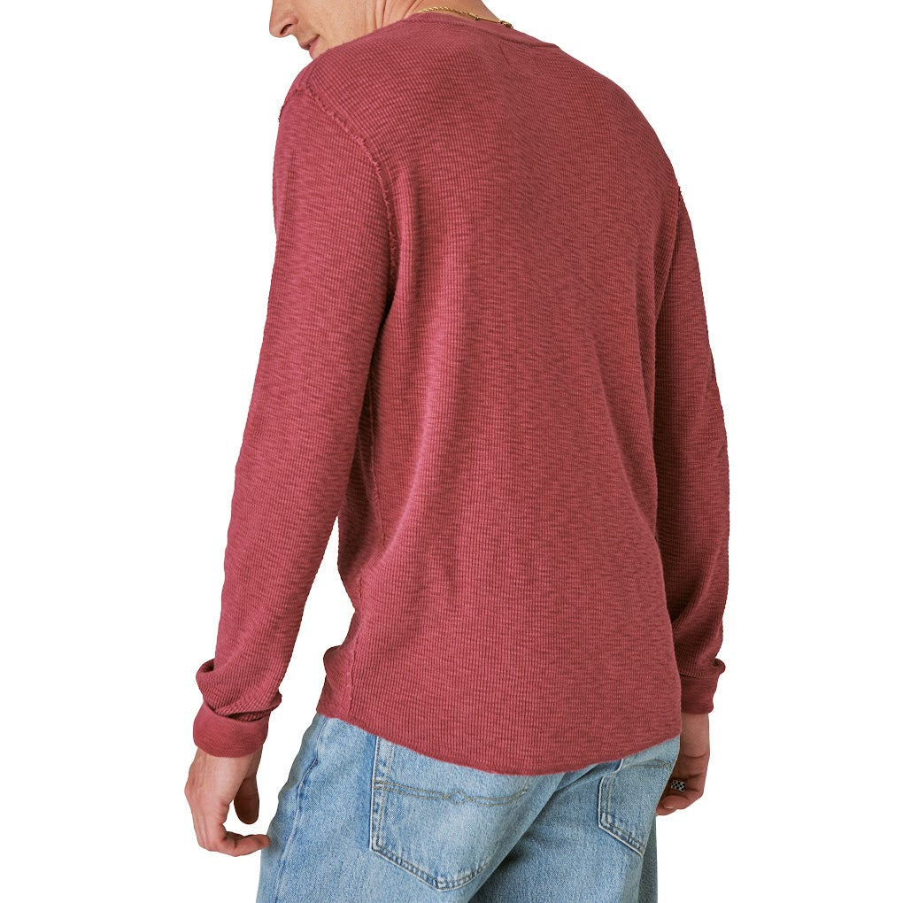 The back view of a man wearing a Guinness Logo Thermal sweater from Guinness Webstore US.