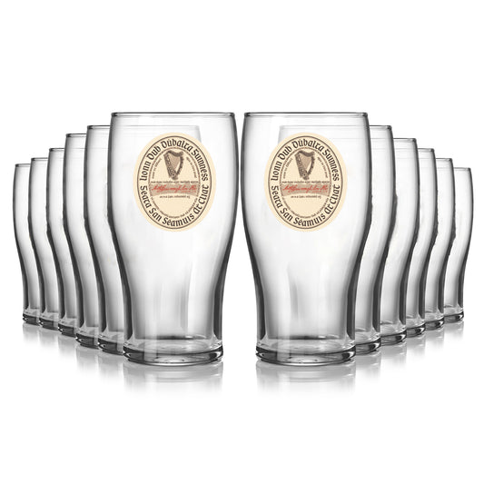Enjoy your Extra Stout with the Guinness Vintage Label Pint Glass - 12 Pack from Guinness Webstore US—each glass features a harp logo and circular text design for an authentic experience.