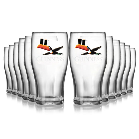 A 12-pack of Guinness Gilroy Flying Toucan Pint Glasses from Guinness Webstore US, each featuring the iconic flying toucan logo, is arranged in rows against a white background.