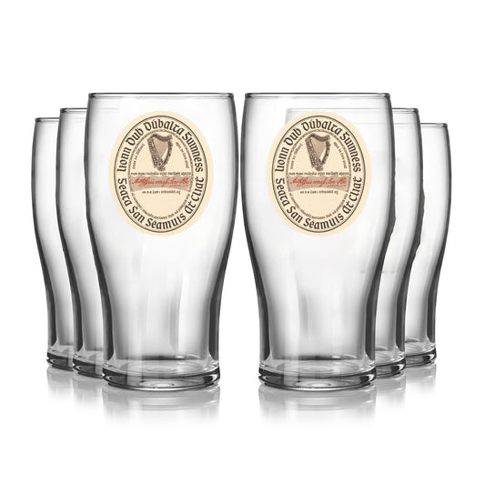 A set of six Guinness Vintage Label Pint Glasses from Guinness Webstore US, inspired by St. James’s Gate Dublin heritage, are arranged in two rows on a white background.