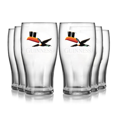 The Guinness Gilroy Flying Toucan Pint Glass - 6 Pack from Guinness Webstore US features six 20oz clear Tulip Glasses with the iconic toucan balancing two pints, arranged in two rows on a white background.