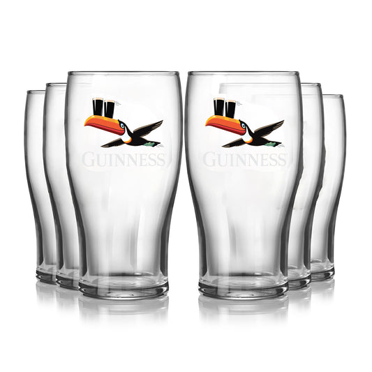 The Guinness Gilroy Flying Toucan Pint Glass - 6 Pack from Guinness Webstore US features six 20oz clear Tulip Glasses with the iconic toucan balancing two pints, arranged in two rows on a white background.