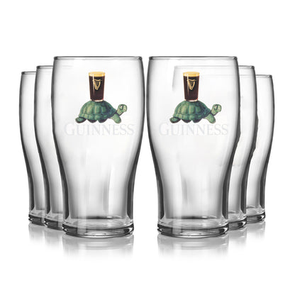 The Guinness Gilroy Tortoise Pint Glass - 6 Pack from Guinness Webstore US features six clear glasses with the iconic tortoise and pint design, inspired by John Gilroy’s classic artwork, and the Guinness logo on each glass.