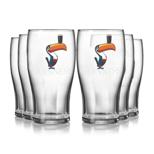 The Guinness Toucan Pint Glass 6 Pack by Guinness features six clear pint glasses, each displaying a colorful toucan with a pint on its beak—ideal for enjoying your favorite brew in style.