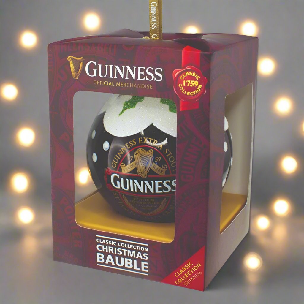 The Guinness Classic Label Glass Bauble, complete with its original packaging, official merchandise tag, and decorative ribbon loop, makes for a perfect festive ornament on your Christmas tree.