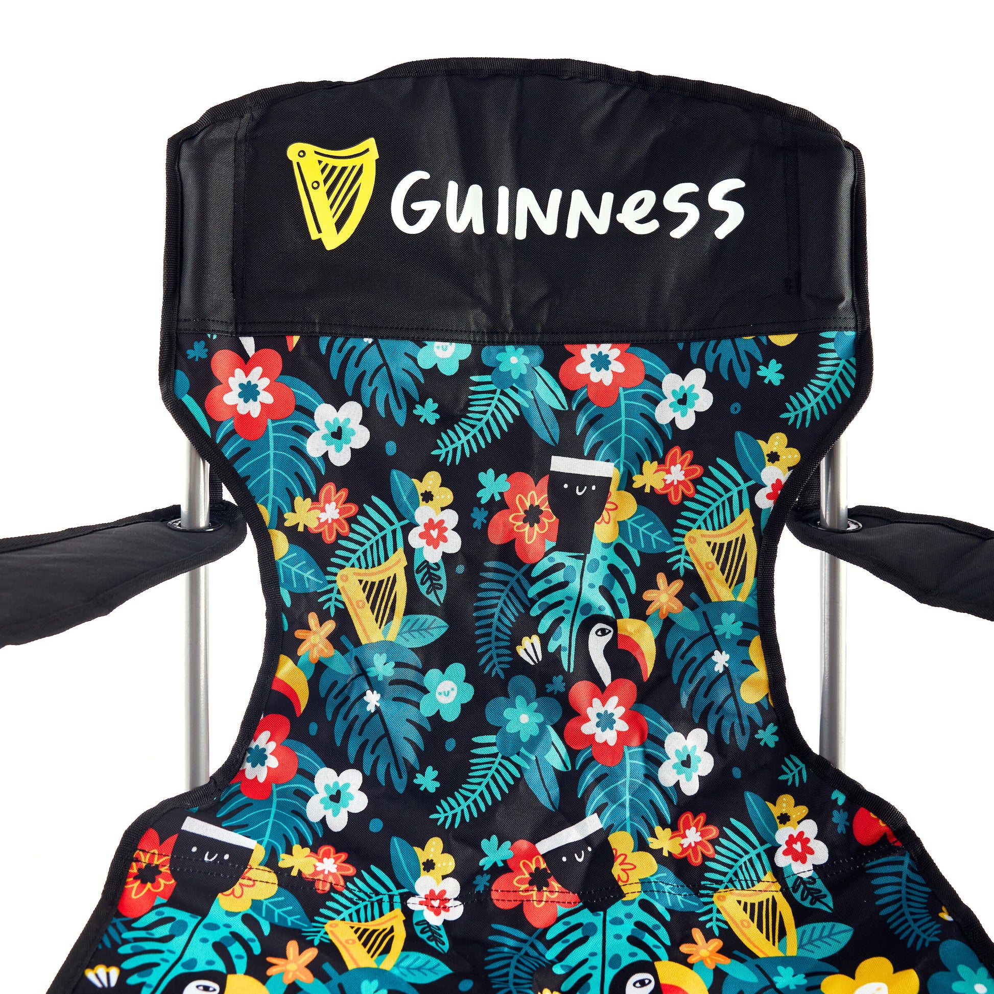 The Guinness x Fatti Burke Hawaiian Camping Chair by Guinness features a vibrant floral and bird pattern with the Guinness logo and harp on the headrest—ideal to pair with your favorite Guinness beach towel for outdoor fun.