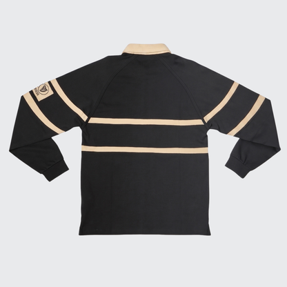 Here is a revised version of the sentence using your product data: The Guinness Black Traditional Rugby Jersey, made from 100% cotton, features long sleeves with two beige horizontal stripes and a beige collar, and is shown from the back. A beige patch on the upper left sleeve highlights the classic style of this rugby shirt by Guinness.