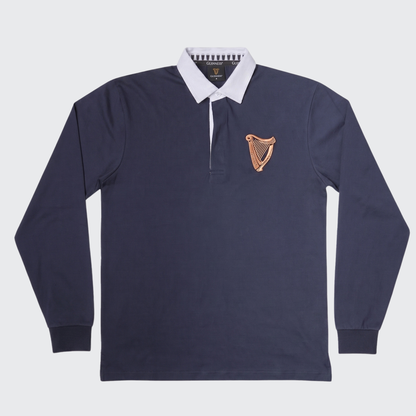 Guinness Webstore US Guinness Navy Traditional Rugby Jersey featuring a classic white collar and a gold harp emblem on the left chest, shown against a plain background.