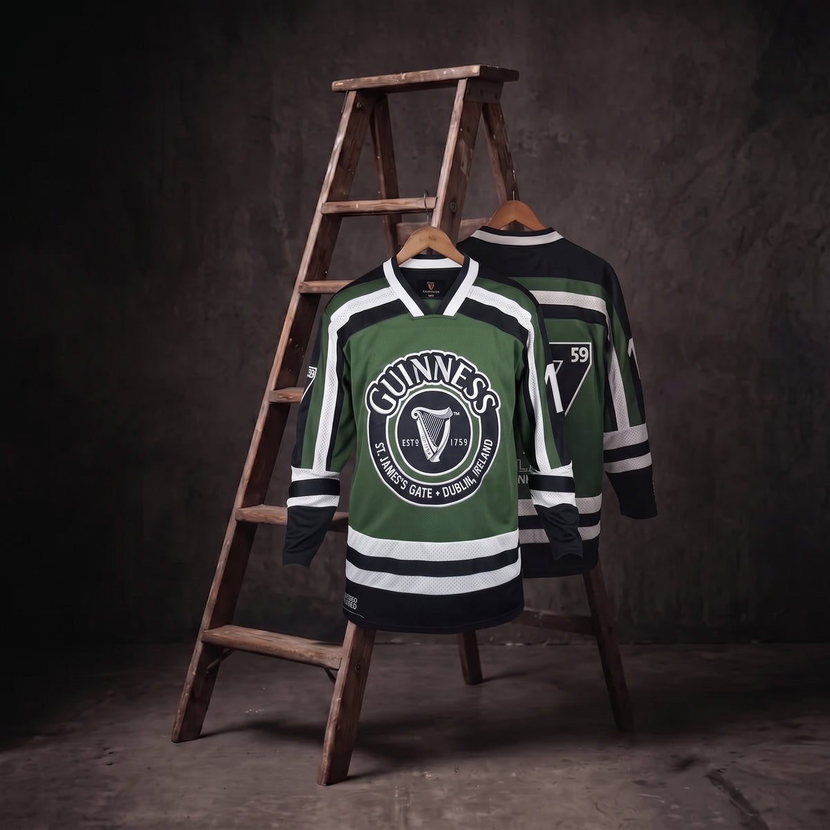 Two Guinness Green & White Hockey Jerseys, each featuring the iconic harp logo, are displayed on a wooden ladder against a dark, textured background.