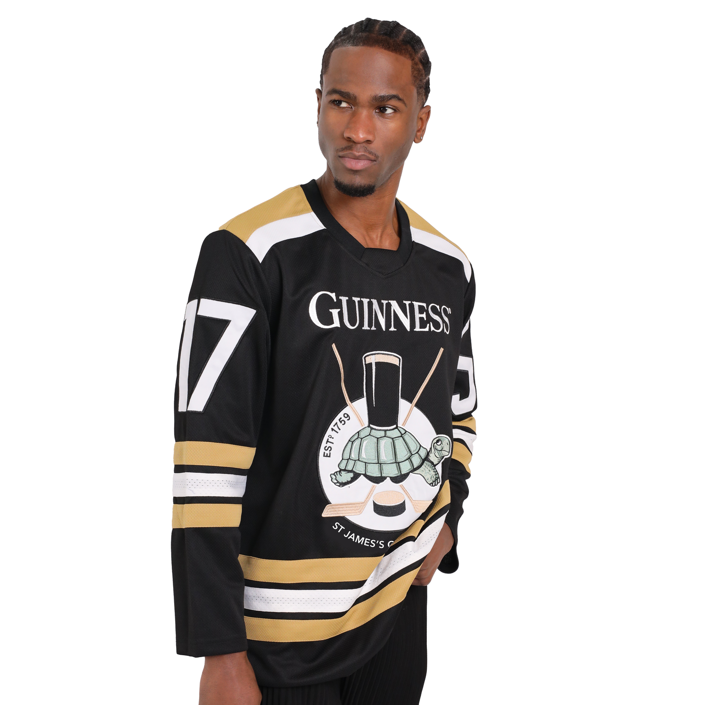 A man wearing a black and white long-sleeve Guinness Tortoise Hockey Jersey from Guinness Webstore US with the number 17 stands with a neutral expression against a plain background.