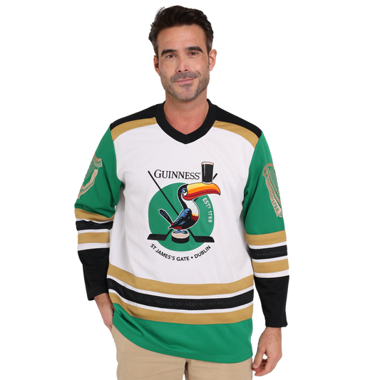 A man donning a Guinness hockey jersey made from sustainable materials and featuring the iconic Guinness Toucan graphic.