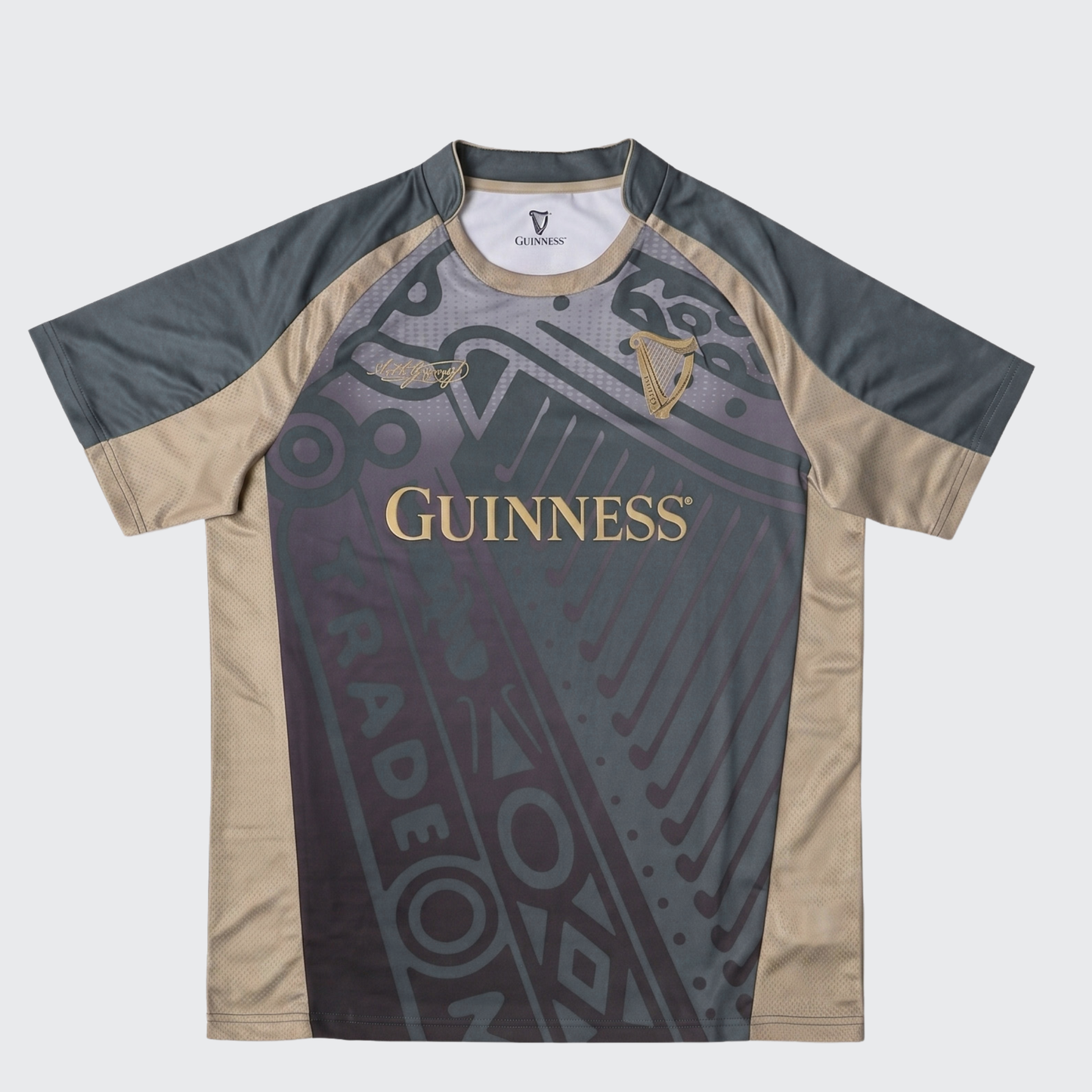 The Guinness Retro Harp Performance Soccer Jersey by Guinness is a short-sleeve athletic shirt featuring black, gray, and beige panels with “Guinness” and harp logos on the front, complemented by abstract graphic design elements—a classic-inspired retro jersey that blends style and performance.