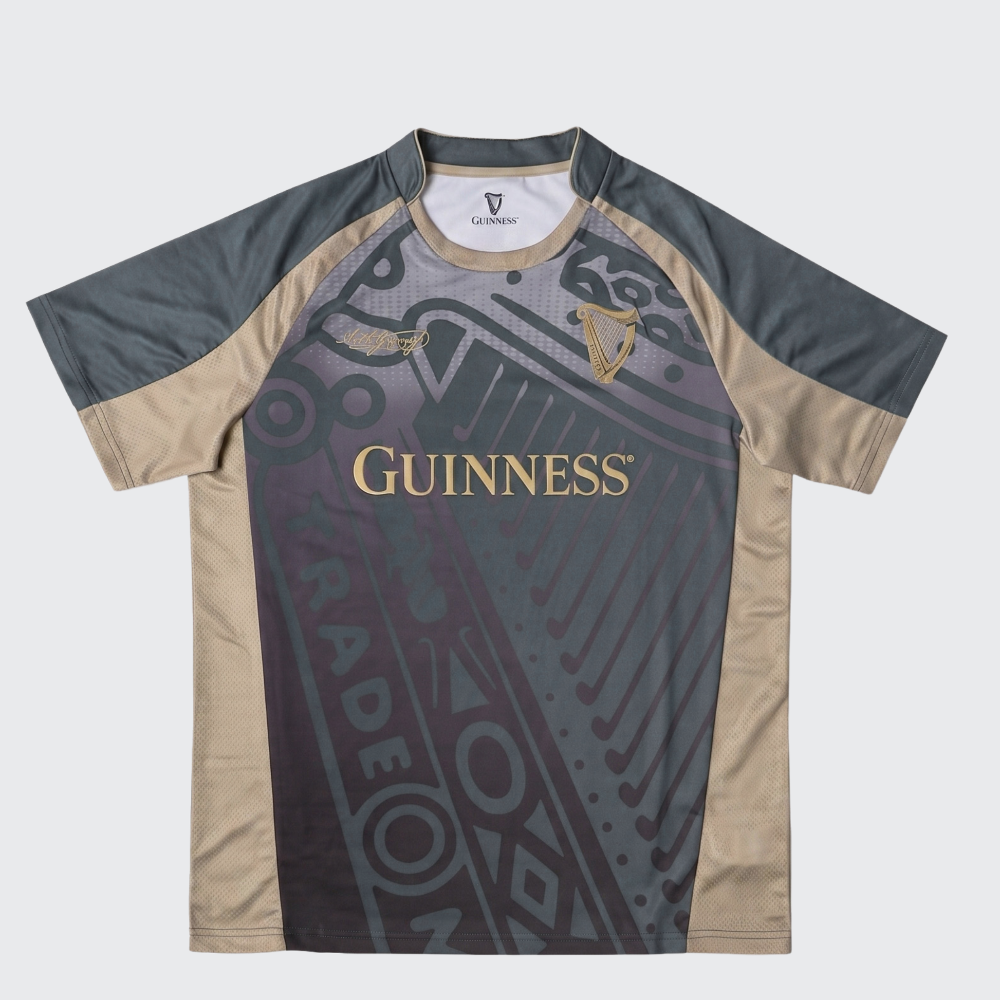 The Guinness Retro Harp Performance Soccer Jersey by Guinness is a short-sleeve athletic shirt featuring black, gray, and beige panels with “Guinness” and harp logos on the front, complemented by abstract graphic design elements—a classic-inspired retro jersey that blends style and performance.